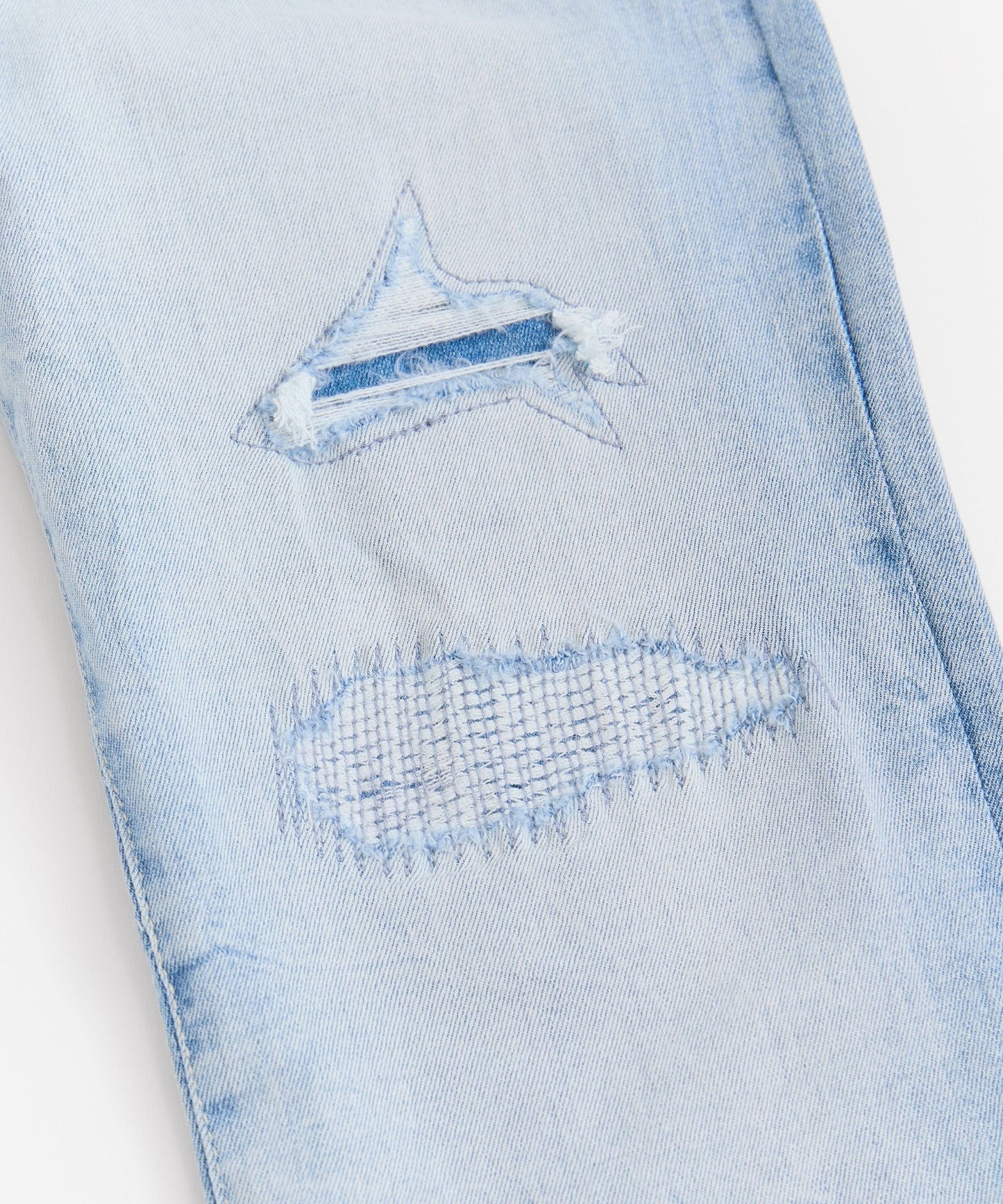 Rip And Repair Light Wash Denim Jeans